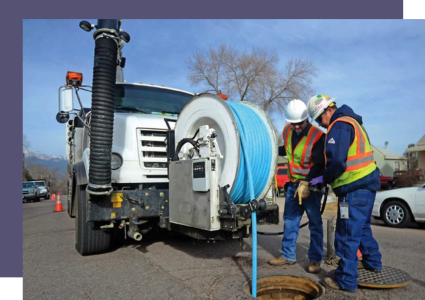 sewage truck working on a man hole