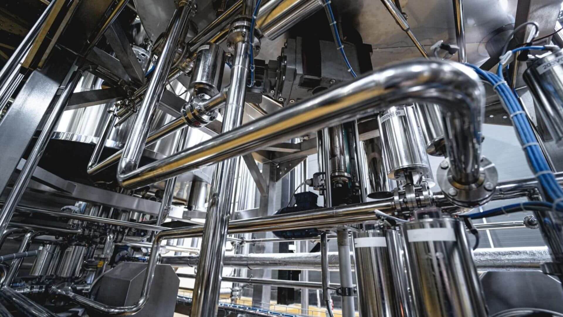 Close-up of stainless steel industrial piping system supporting chemical product distribution in California facility